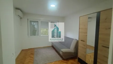 Living room with a sofa, wardrobe and wooden flooring. - image 6