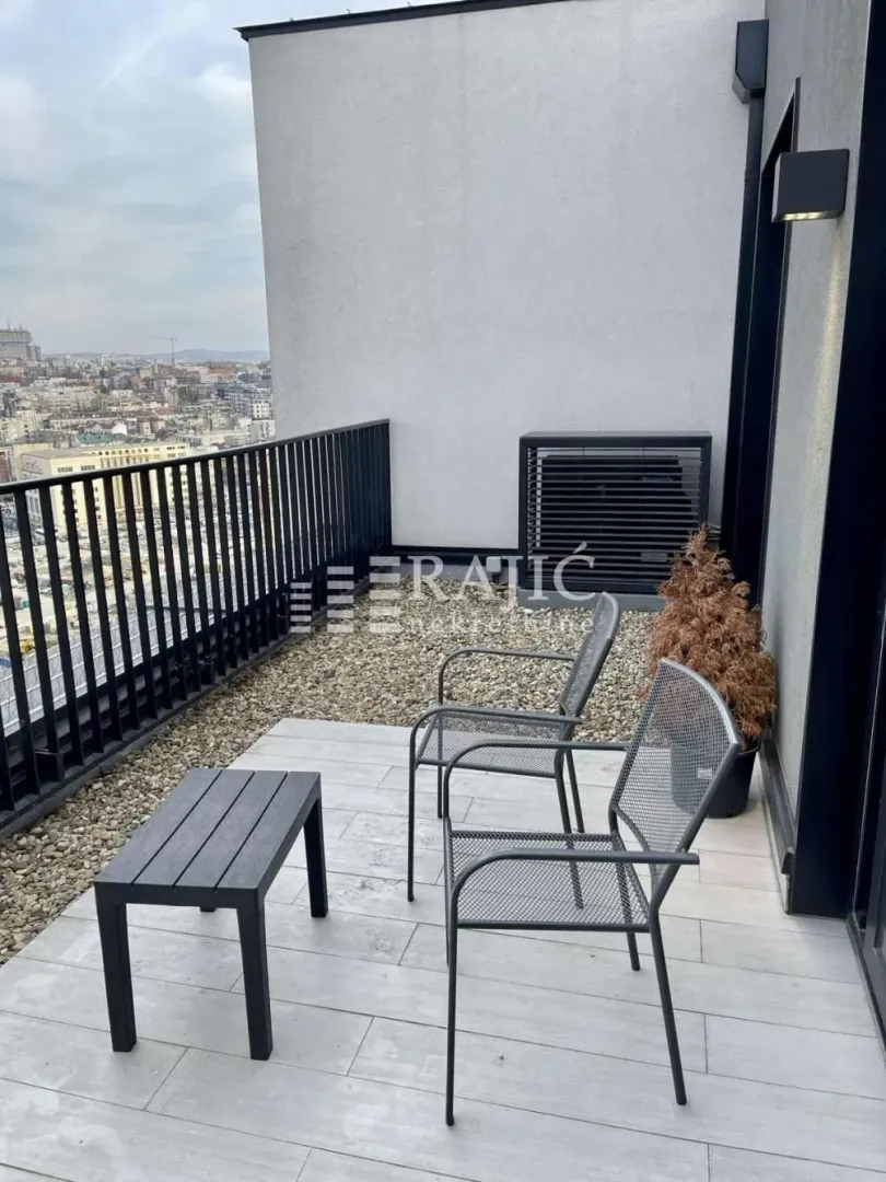 Modern terrace with seating furniture and city view.