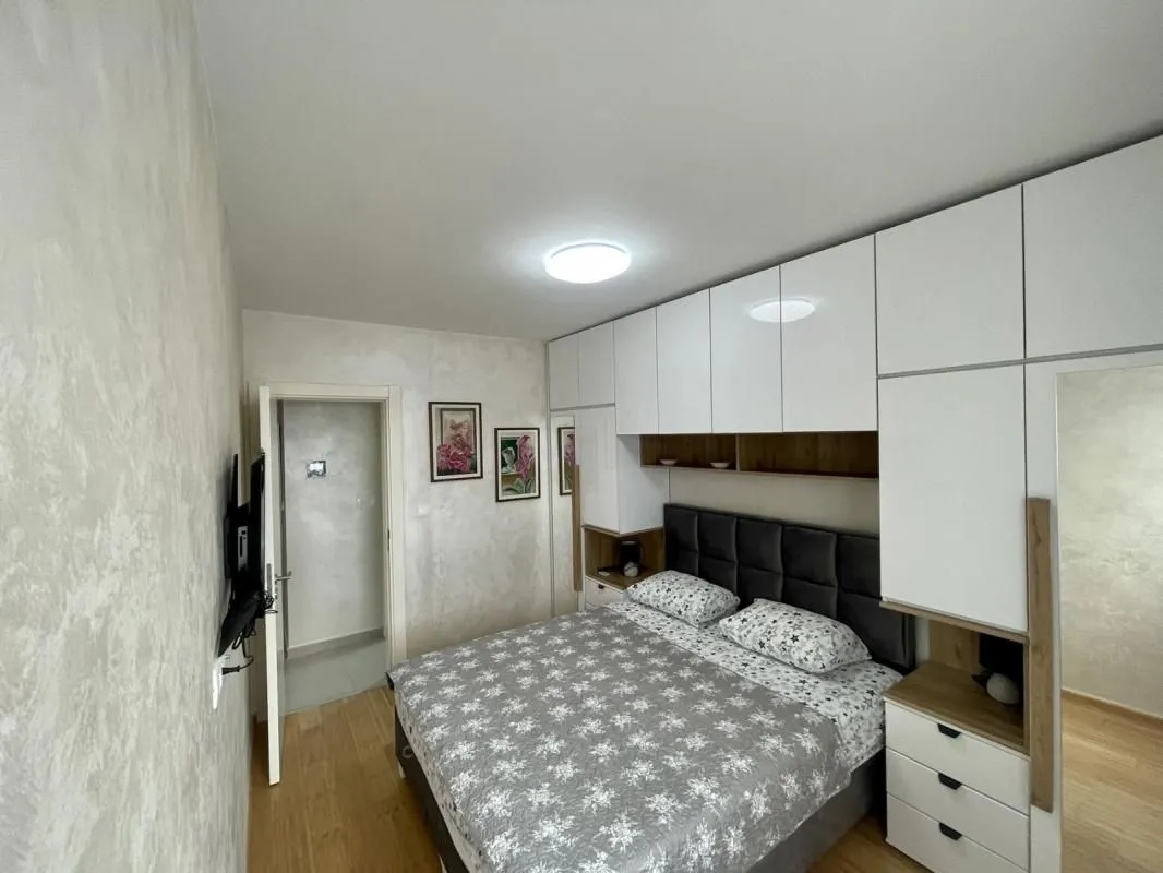 Furnished bedroom with a double bed and fitted wardrobes.