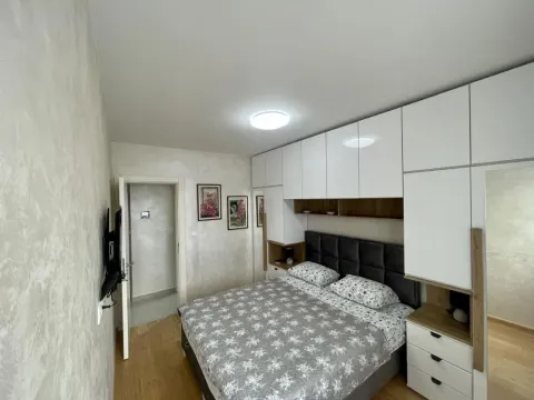Furnished bedroom with a double bed and fitted wardrobes. - image 8