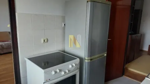 Small kitchen with a stove and a refrigerator. - image 7