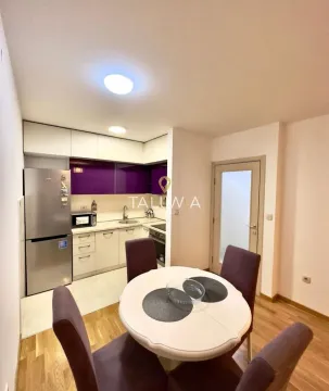 Kitchen with dining area and a table with four chairs. - image 3