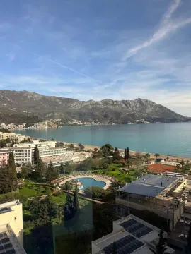 View from the window overlooking the sea, coast, and mountains in the background. - image 11