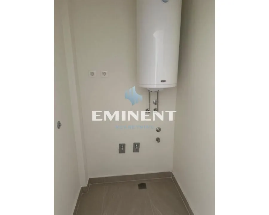 View of a bathroom section with a water heater and appliance connections.