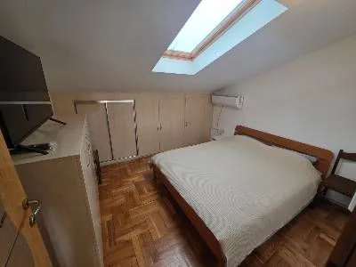 Attic bedroom with a double bed and a skylight. - image 3