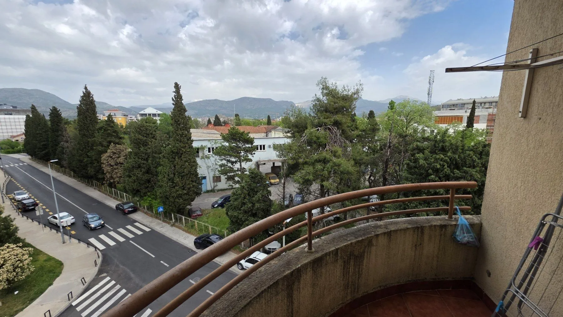 View from the balcony showing the street and hills.