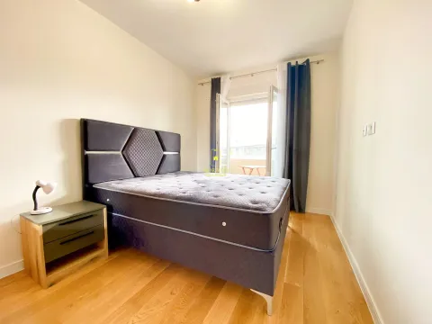 Bedroom with a double bed, bedside table, and access to the terrace. - image 5