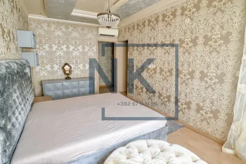 Spacious bedroom with a double bed, patterned wallpaper, and decorative ceiling. - image 9