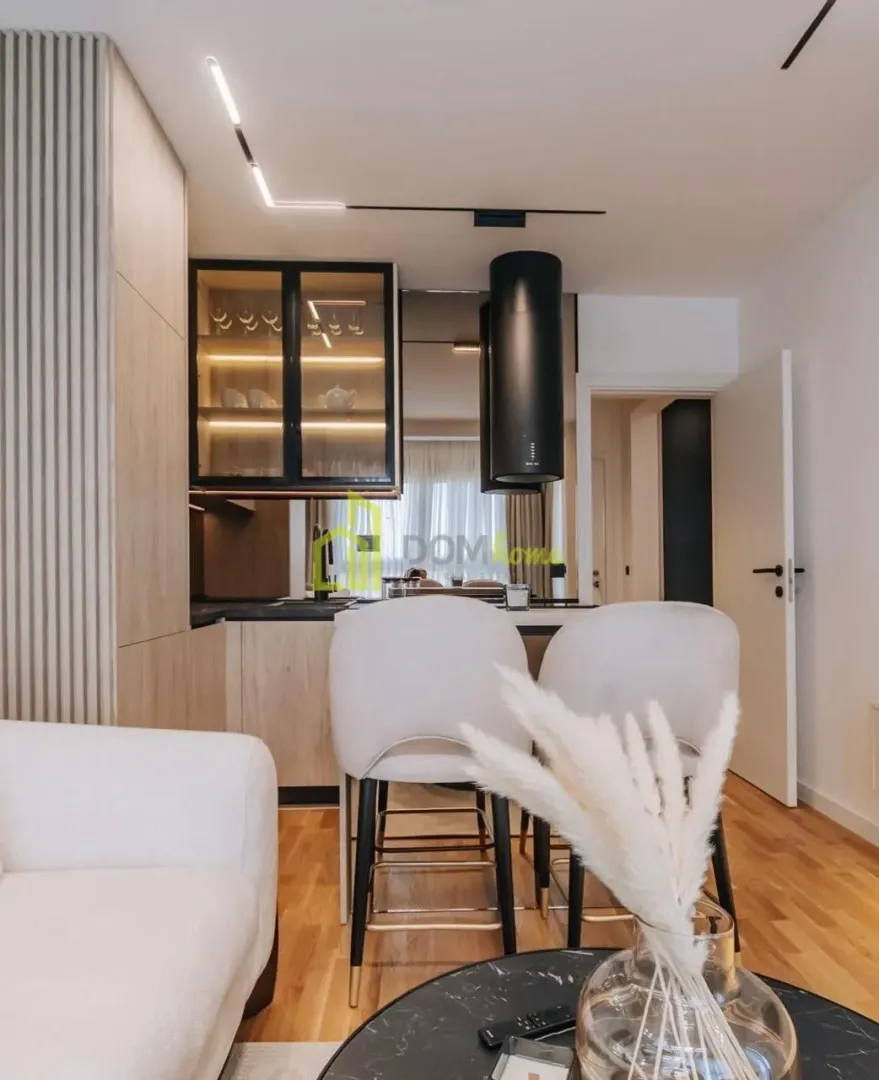 Modern kitchen with a breakfast bar and bar stools.