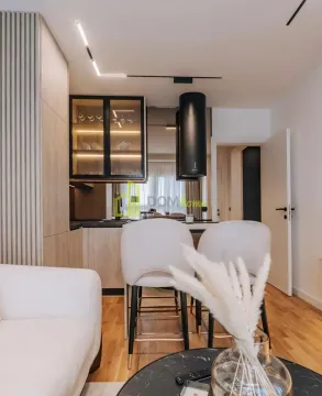 Modern kitchen with a breakfast bar and bar stools. - image 8