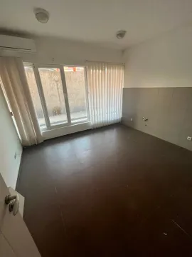 Empty room with dark floor tiles and a window. - image 6