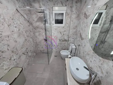 Modern bathroom with a walk-in shower, washbasin, and toilet. - image 11