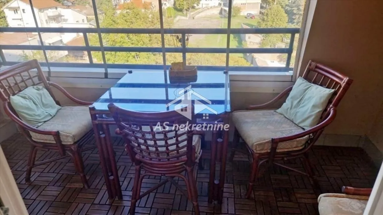 Furnished balcony with a table and chairs.