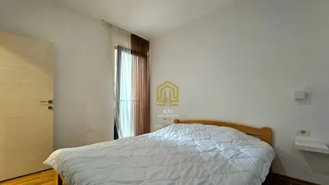 Bedroom with a double bed and a window with curtains. - image 8