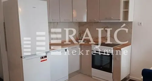Smaller kitchen equipped with basic home appliances.
