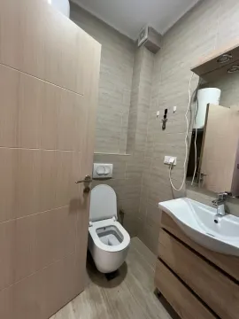 Smaller bathroom with a sink, mirror, and toilet bowl. - image 8
