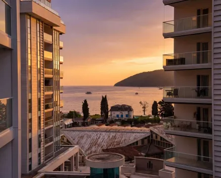 View from the terrace of the sea and sunset between buildings. - image 12
