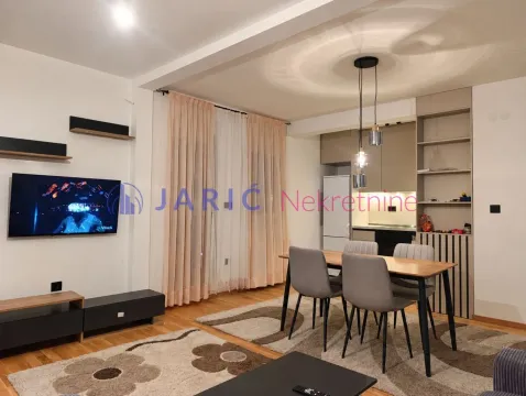 Living room with dining area and kitchen in the background. - image 3