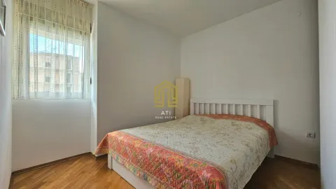 Bright bedroom with a double bed and wooden flooring. - image 6