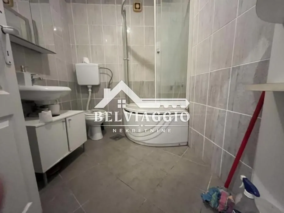 Bathroom with a shower cabin, washbasin, and toilet.