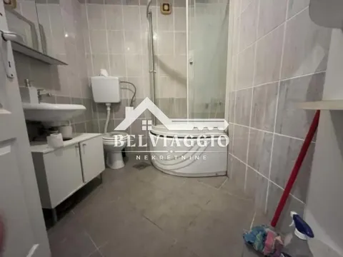 Bathroom with a shower cabin, washbasin, and toilet. - image 7