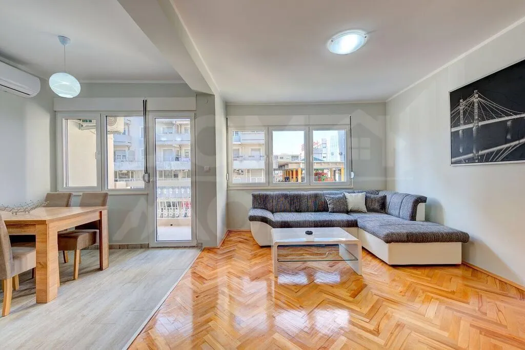 Spacious living room with sofa set and dining area.