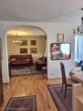 Living room with a sofa set and a dining area connected by an archway. - image 14