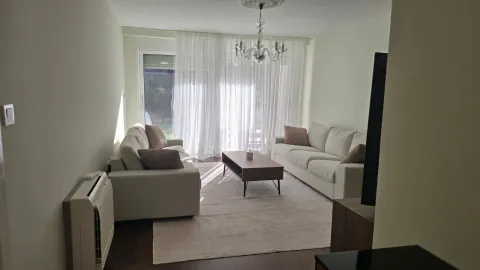 Spacious living room with sofa set and large windows. - image 6