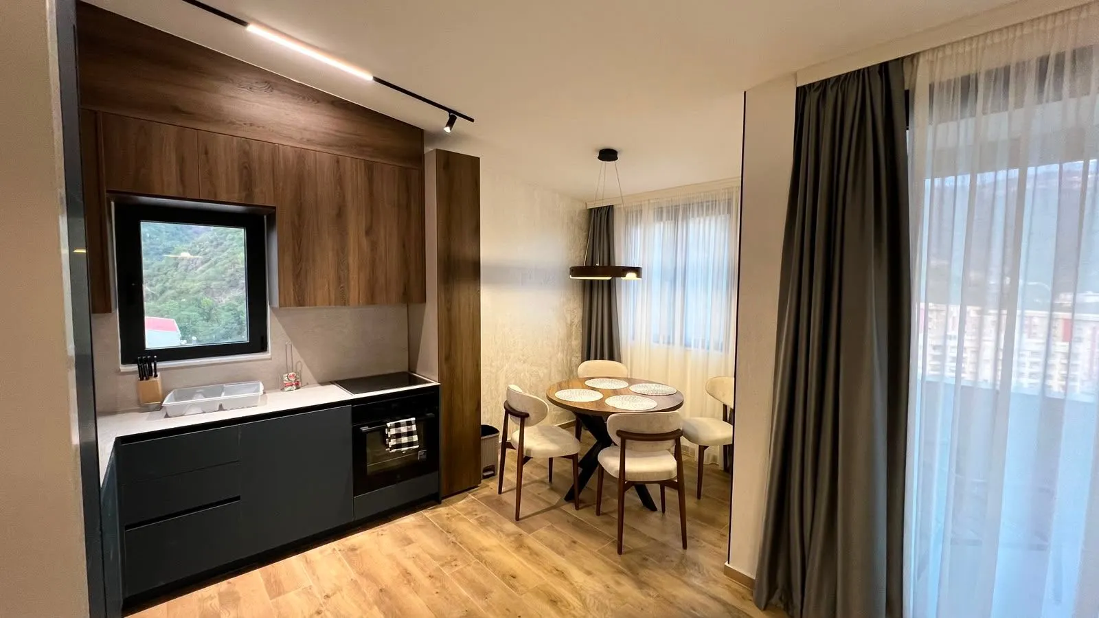 Modern kitchen with a dining area and built-in appliances.