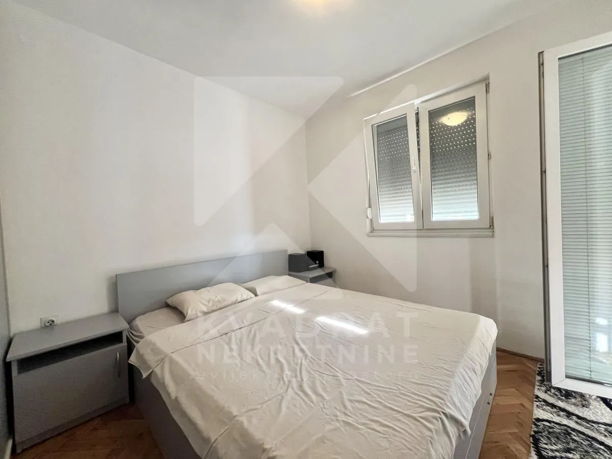 Bedroom with a double bed, bedside tables, and a window.