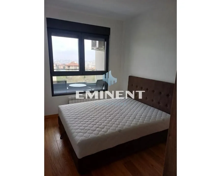 Bedroom with a large double bed and a window.