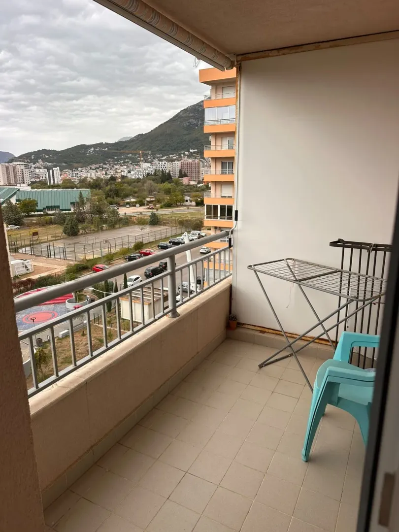 Balcony with a view of the city and surrounding mountains.