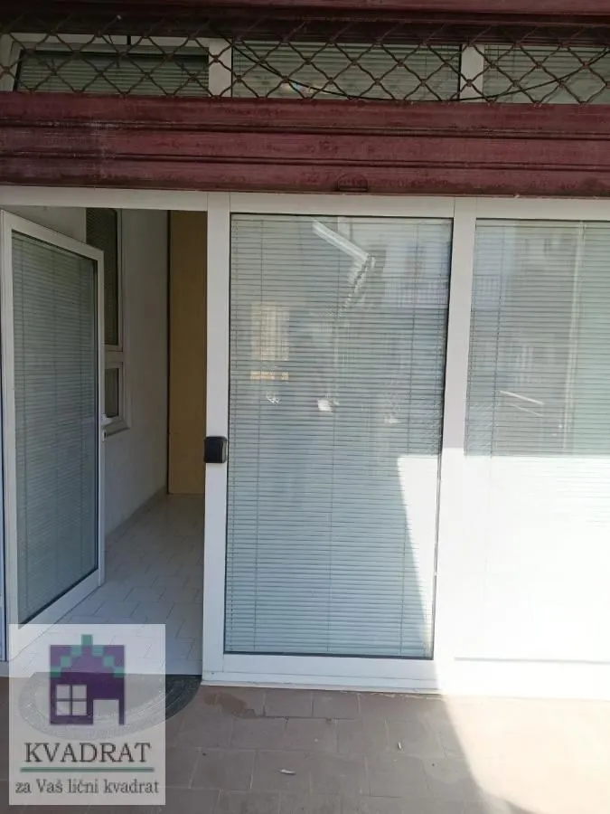 Entrance to a commercial space with glass doors and windows.