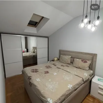 Furnished bedroom with a double bed and a fitted wardrobe. - image 2
