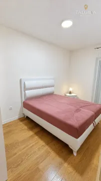 Spavaća soba sa bračnim krevetom i noćnim stočićem. - image 4