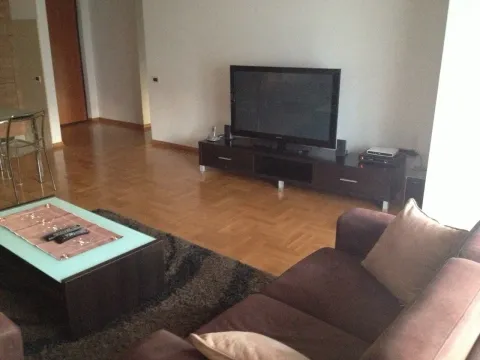Bright living room with a sofa and a television. - image 3