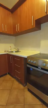 Kitchen cabinets with a sink and stove. - image 5