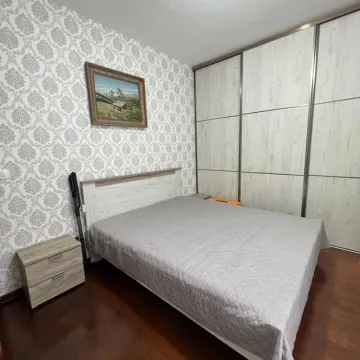 Bedroom with a double bed, bedside table, and a large built-in wardrobe. - image 6