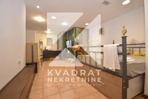 Bedroom with a bed and tiled flooring in the apartment. - image 7