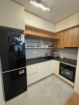 Modern kitchen with white and wooden cabinets and a black refrigerator. - image 8