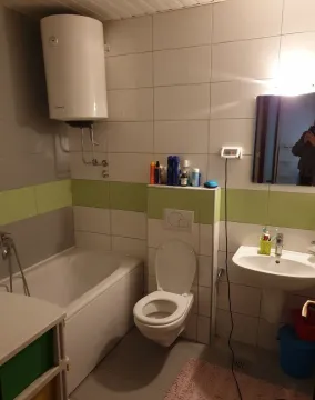 Bathroom with a bathtub and boiler. - image 8
