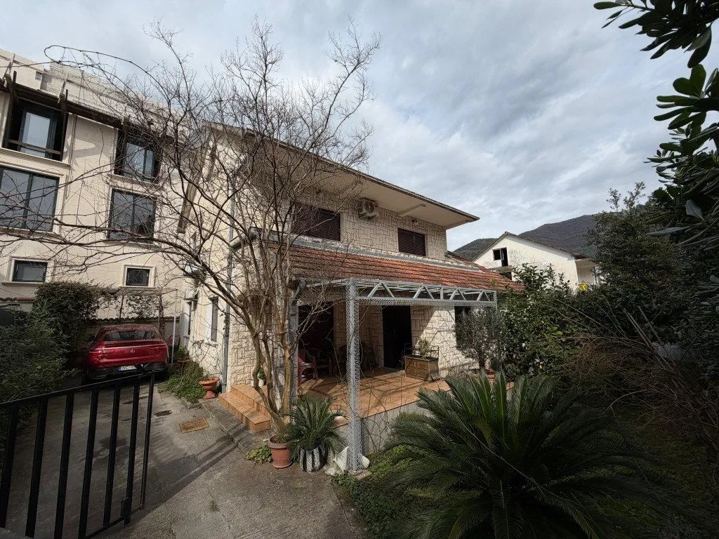 Exterior of a family house with a yard and terrace.