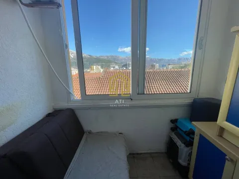 Smaller bedroom with a bed and a view of the mountains through the window. - image 6