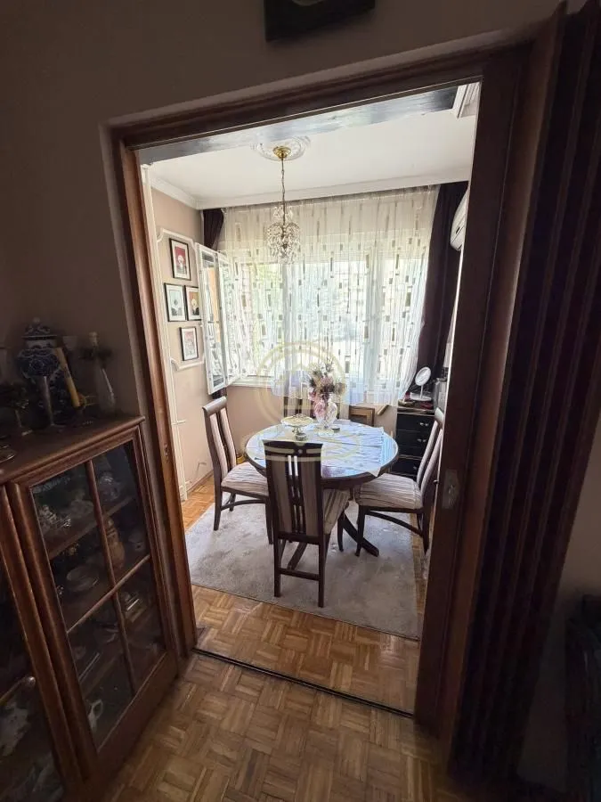 View from the hallway into the dining area with a table and chairs.