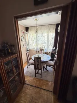 View from the hallway into the dining area with a table and chairs. - image 4