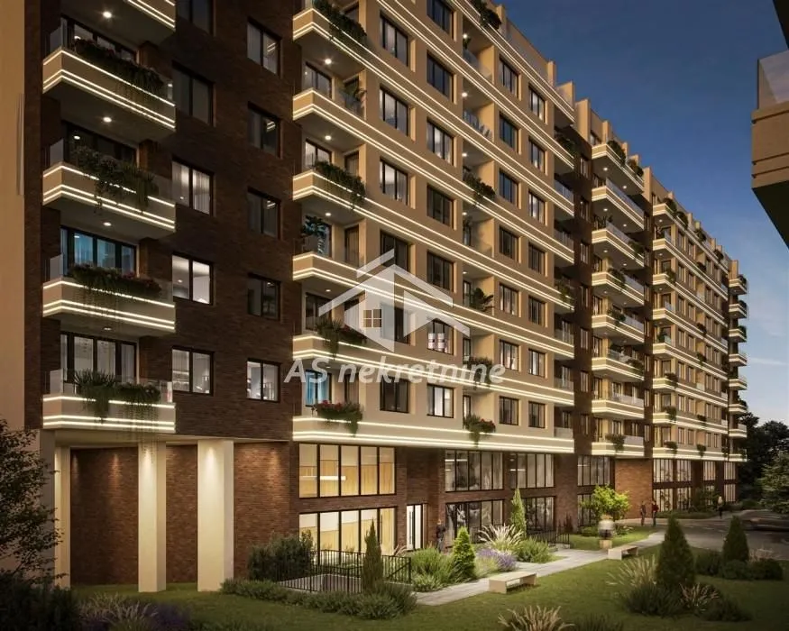 Exterior of the residential building with illuminated terraces and landscaped courtyard.