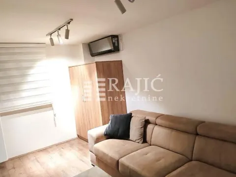 Living room with a sofa, wardrobe, and air conditioning. - image 3