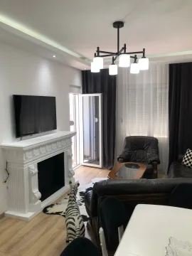 Spacious living room with a fireplace, seating area, and dining table. - image 11