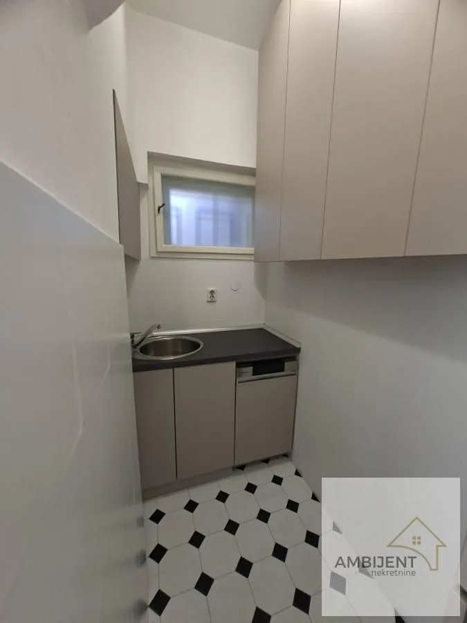 Small kitchen with a sink, cabinetry, and a built-in dishwasher.