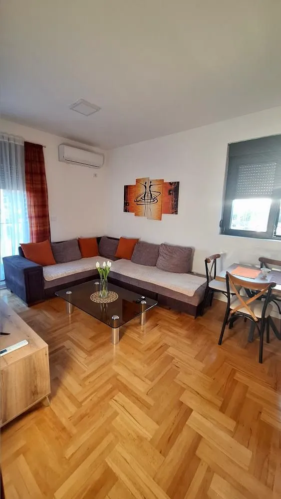 Living room with a sectional sofa, coffee table, and dining area.